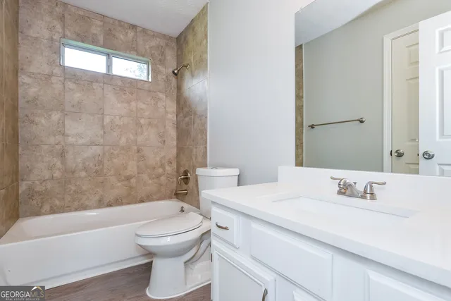 a bathroom with a sink a toilet and a bathtub
