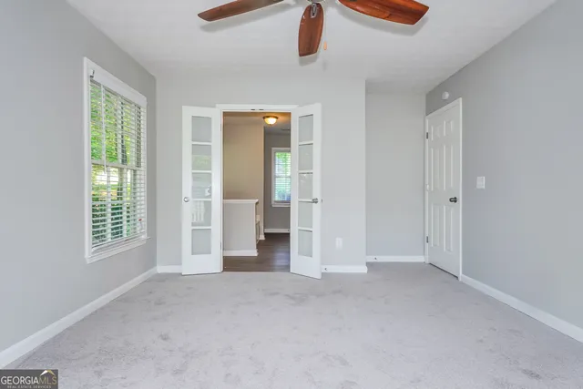 an empty room with windows and closet