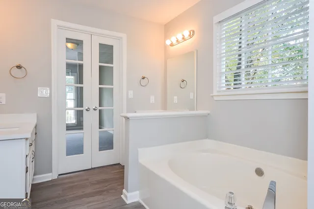 a white bath tub sitting next to a white sink