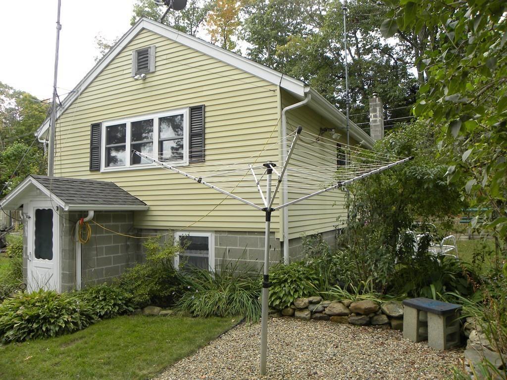 66 Osgood Road Charlton, MA 01507 - Photo 17 of 42 a yellow house with trees in front of it