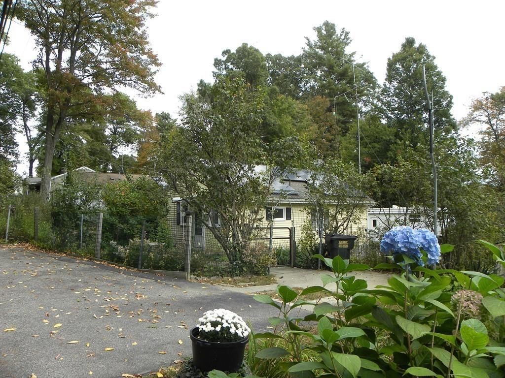 66 Osgood Road Charlton, MA 01507 - Photo 18 of 42 a front view of a house with a yard and a garden