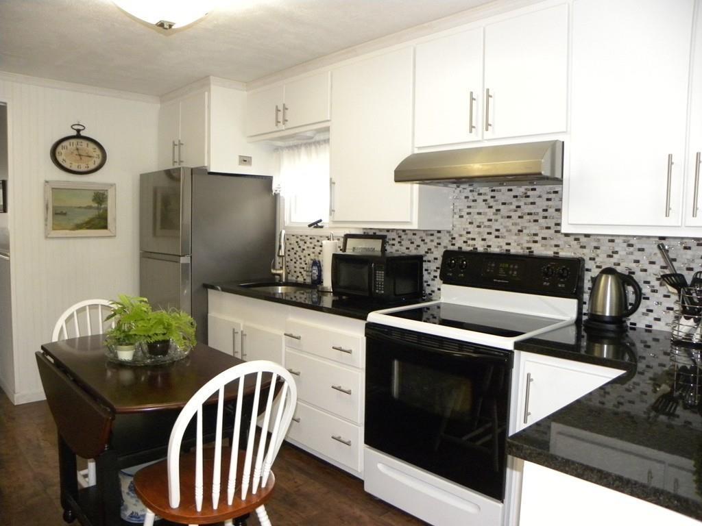 66 Osgood Road Charlton, MA 01507 - Photo 25 of 42 a kitchen with stainless steel appliances granite countertop a stove a refrigerator and a microwave