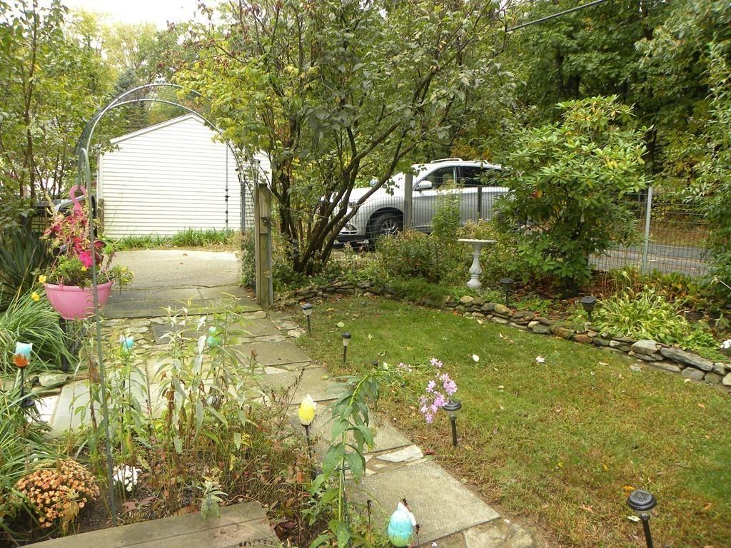 66 Osgood Road Charlton, MA 01507 - Photo 36 of 42 a backyard of a house with a yard and outdoor seating