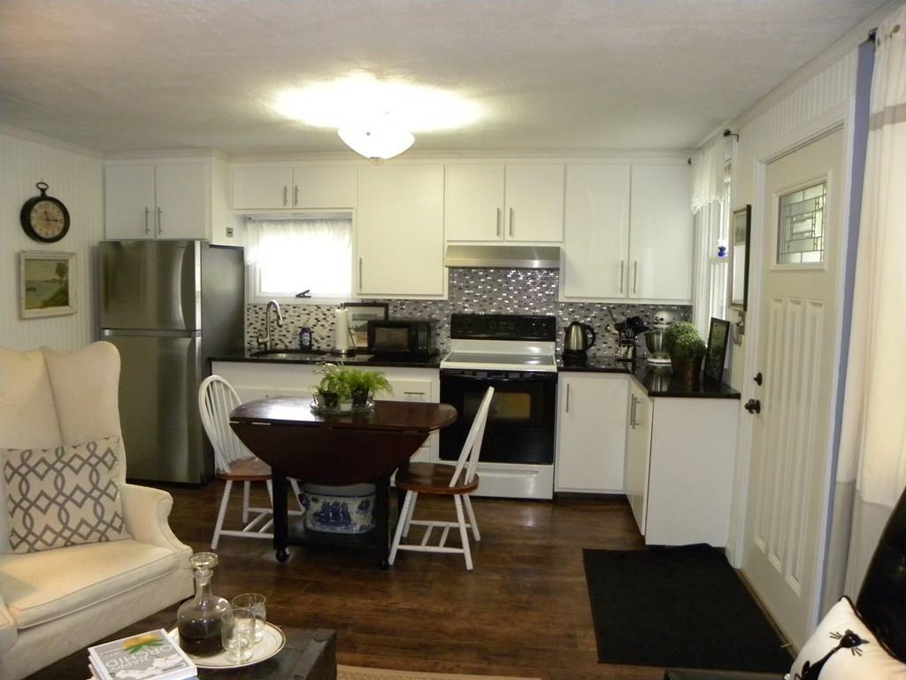 66 Osgood Road Charlton, MA 01507 - Photo 8 of 42 a kitchen with stainless steel appliances kitchen island granite countertop a refrigerator a stove a sink and white appliances