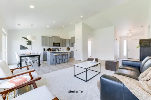 a living room with furniture and kitchen view