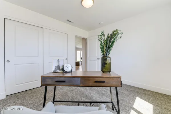 a view of a workspace room with wooden floor