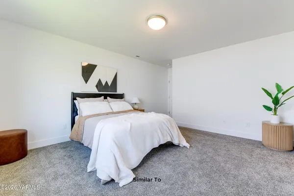 a bed room with a bed and a chair