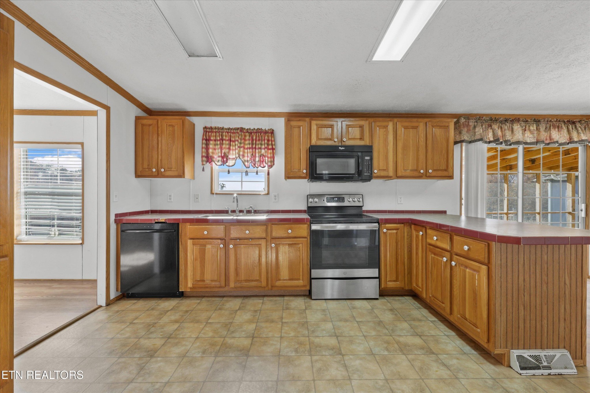 1130 Williamson Chapel Road Maryville, TN 37801 - Photo 16 of 36 a kitchen with stainless steel appliances granite countertop a stove sink and cabinets
