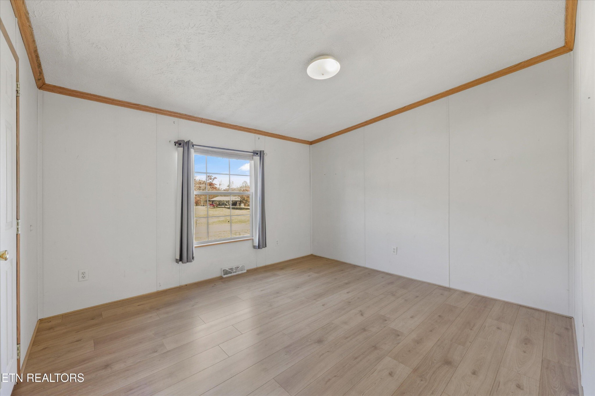 1130 Williamson Chapel Road Maryville, TN 37801 - Photo 26 of 36 a view of an empty room with wooden floor and a window