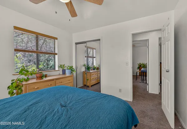 a bedroom with a bed and a large window