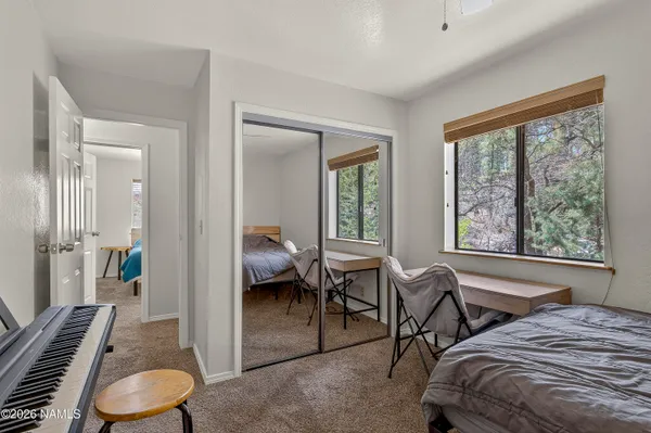 a bedroom with a bed and a large window