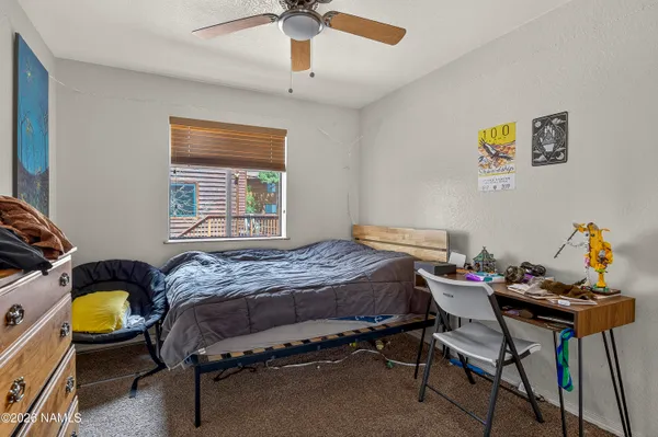 a bedroom that has a bed and a chair in it