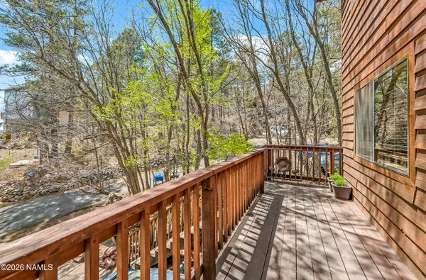 a view of balcony with wooden floor and fence