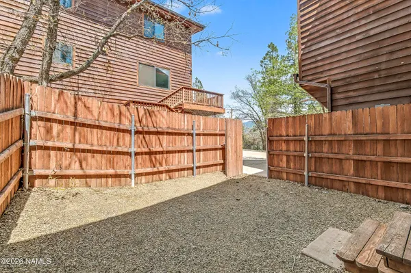 a view of a house with a yard and wooden fence