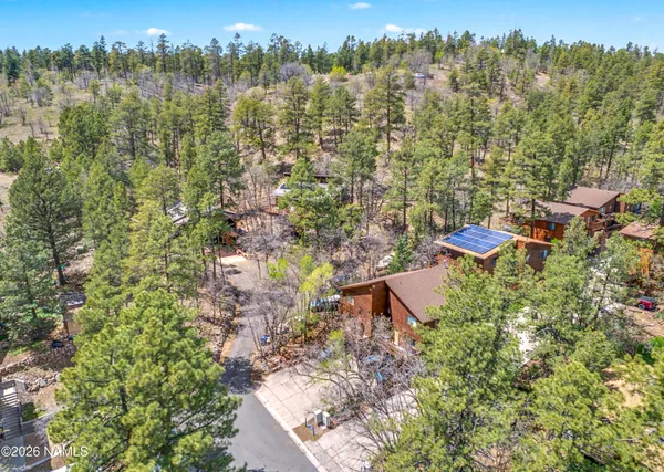 an aerial view of a house with yard and outdoor seating