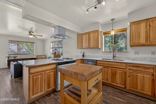 a kitchen with a sink stove and cabinets
