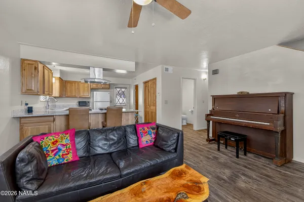 a living room with furniture and kitchen