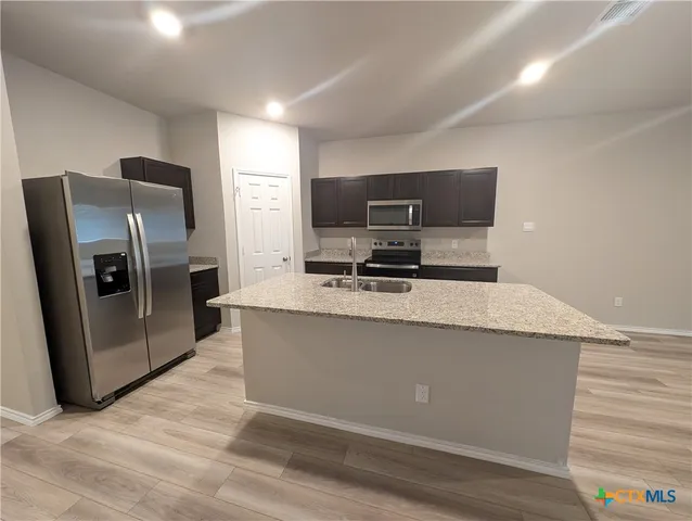 a view of a livingroom with a dishwasher and cabinets