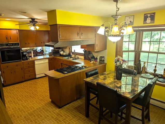 a kitchen with a stove a sink and a refrigerator
