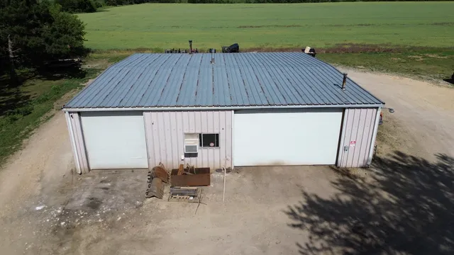 a view of backyard with table and chair under an umbrella