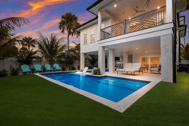 a view of a patio with swimming pool table and chairs