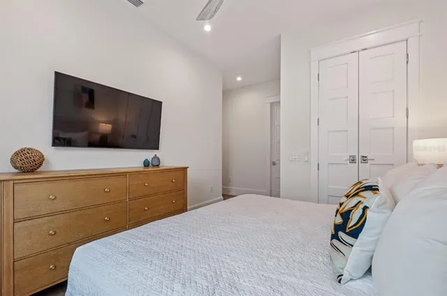 a bedroom with a bed and a painting on the wall