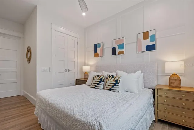 a bedroom with a bed and a painting on the wall