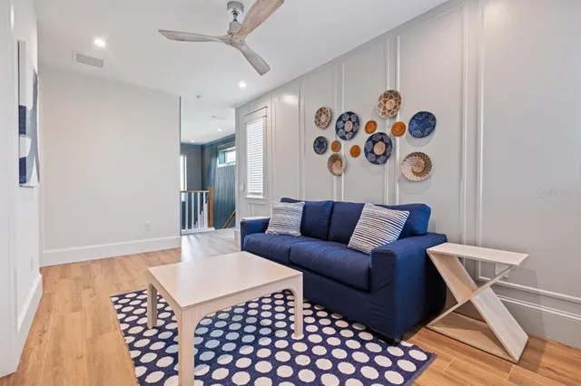 a dining room with furniture and a floor to ceiling window