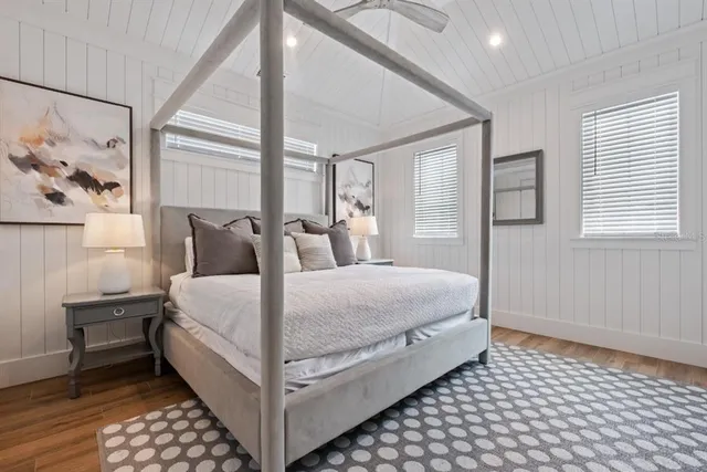 a view of a house with swimming pool lawn chairs and a yard