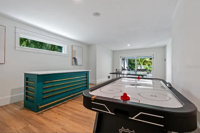 an aerial view of ocean and residential houses with outdoor space