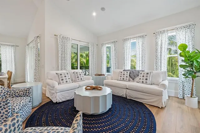 a kitchen with stainless steel appliances kitchen island granite countertop a stove a sink a dining table and chairs with wooden floor