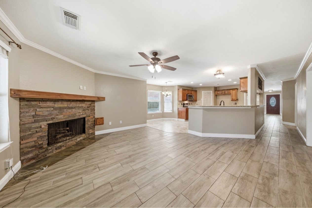 13506 Spring Court Tomball, TX 77375 - Photo 6 of 37 a view of a livingroom with wooden floor and a kitchen