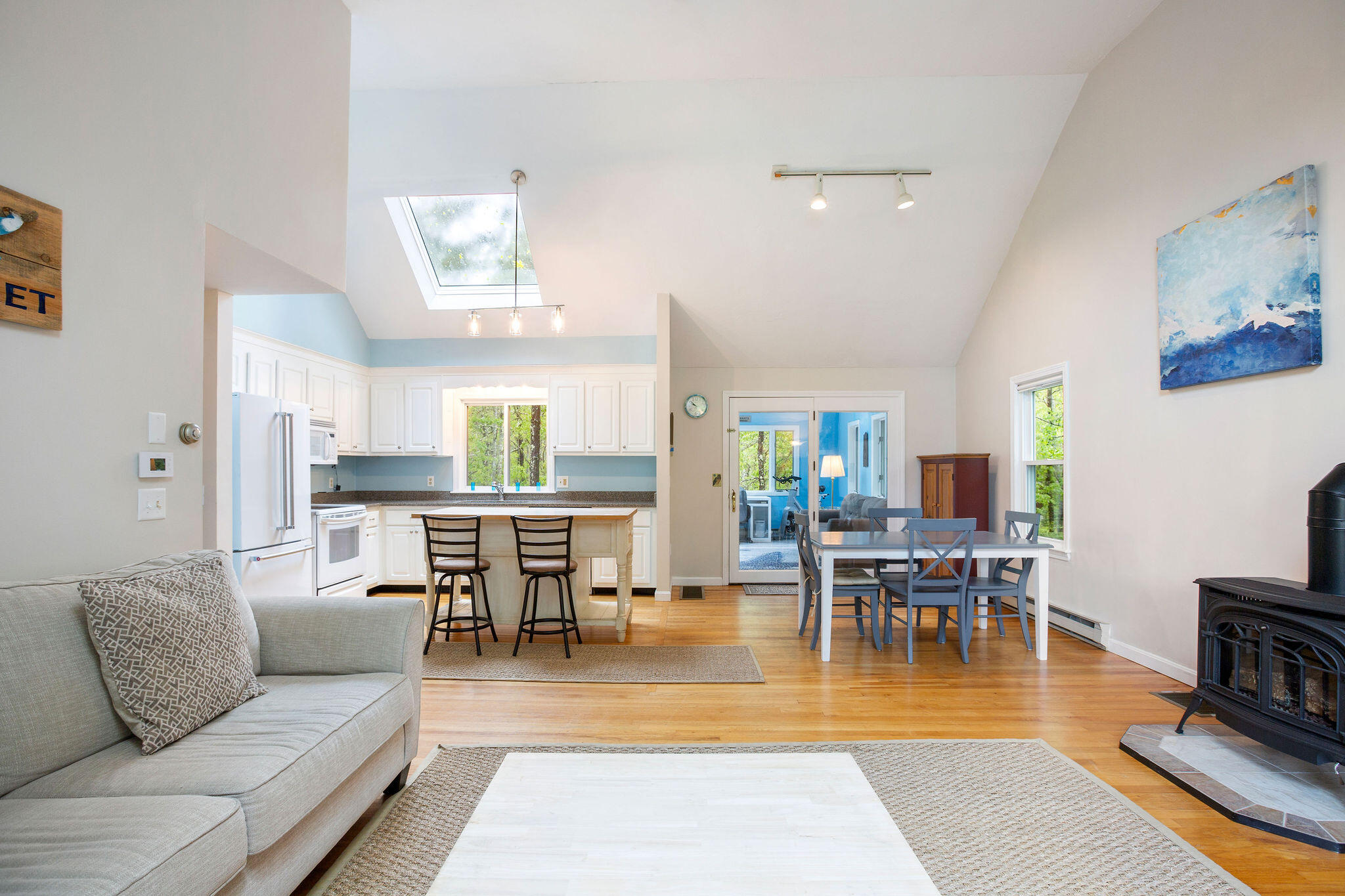 94 Pine View Drive Brewster, MA 02631 - Photo 12 of 51 a living room with furniture a dining table and a fireplace