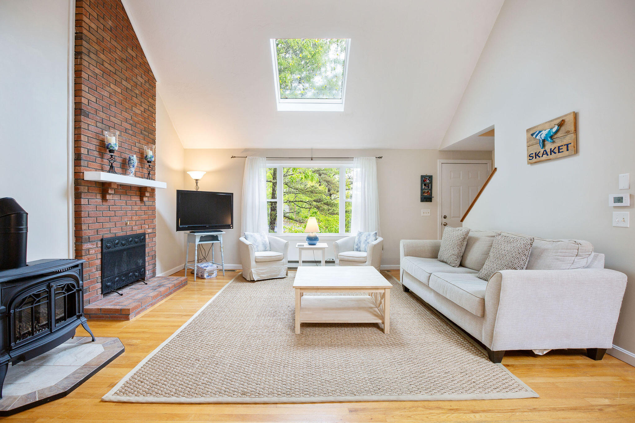 94 Pine View Drive Brewster, MA 02631 - Photo 15 of 51 a living room with furniture a flat screen tv and a fireplace