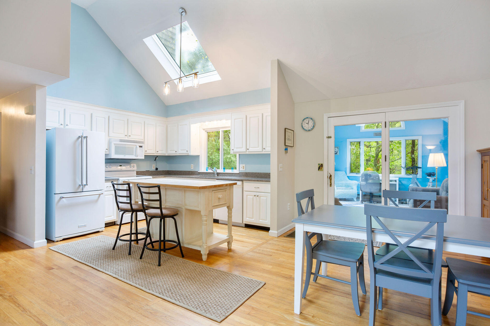 94 Pine View Drive Brewster, MA 02631 - Photo 19 of 51 a kitchen with stainless steel appliances granite countertop a dining table chairs refrigerator and sink