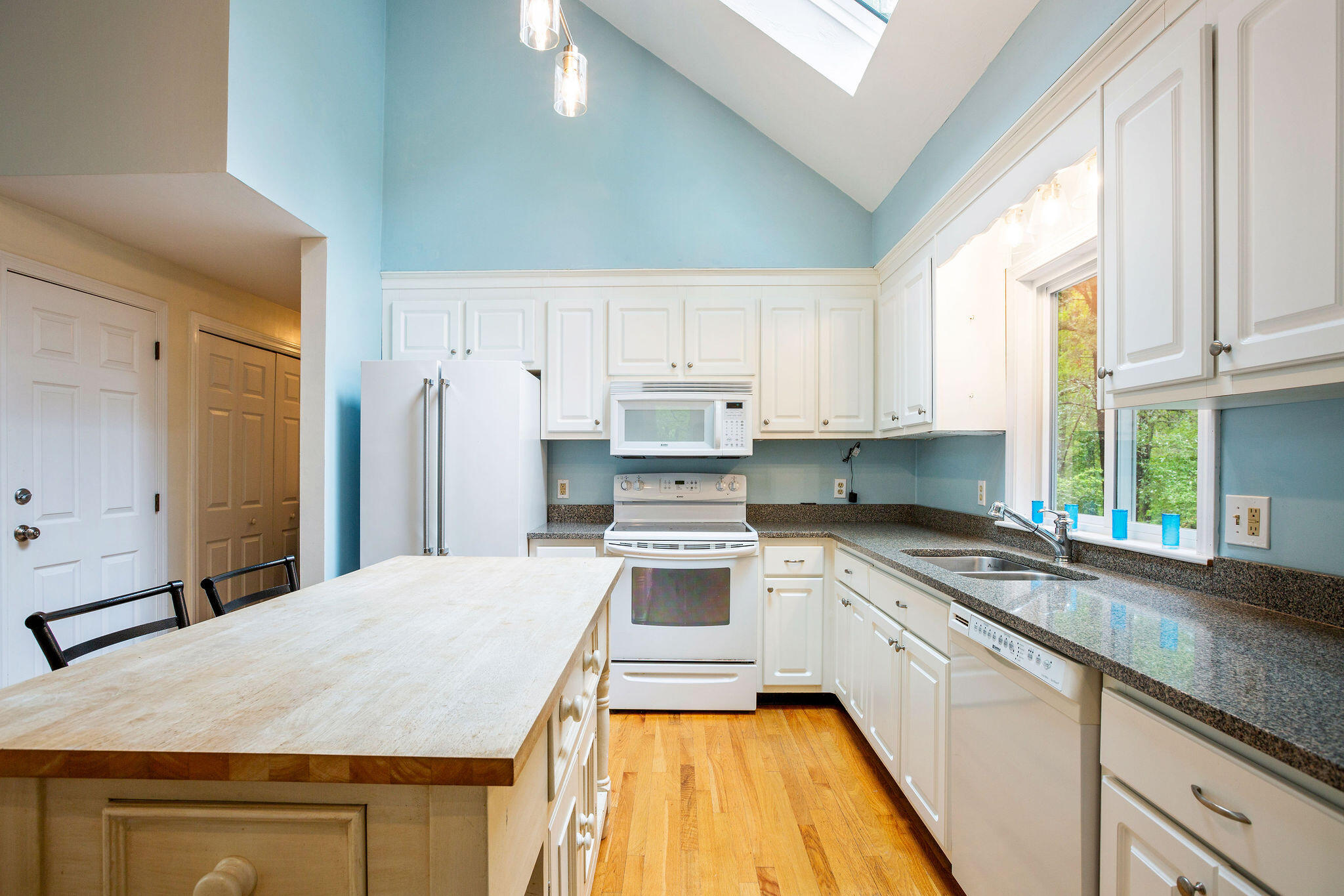 94 Pine View Drive Brewster, MA 02631 - Photo 23 of 51 a kitchen with stainless steel appliances granite countertop a stove a sink and white cabinets