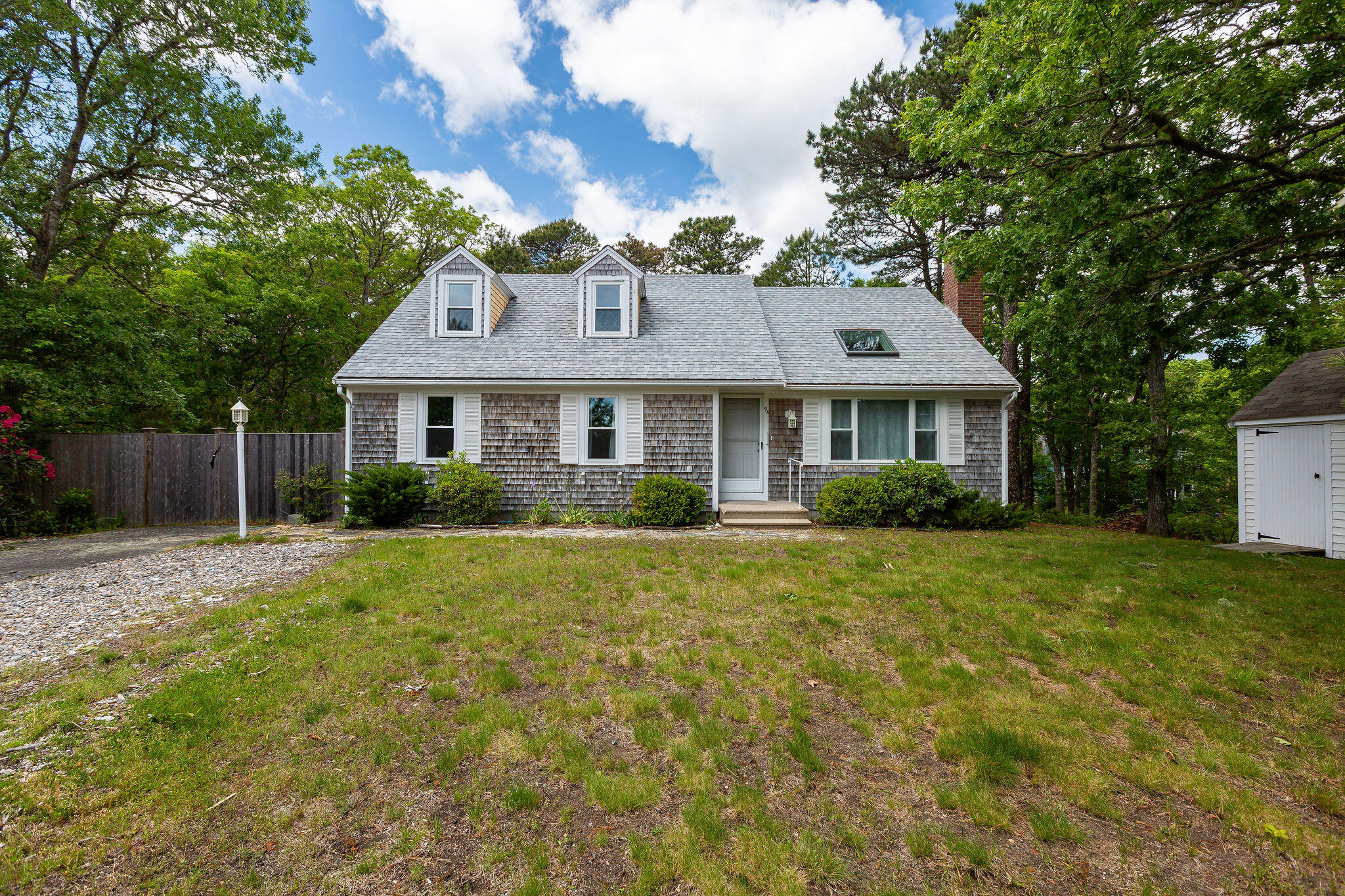 94 Pine View Drive Brewster, MA 02631 - Photo 3 of 51 a front view of a house with a yard