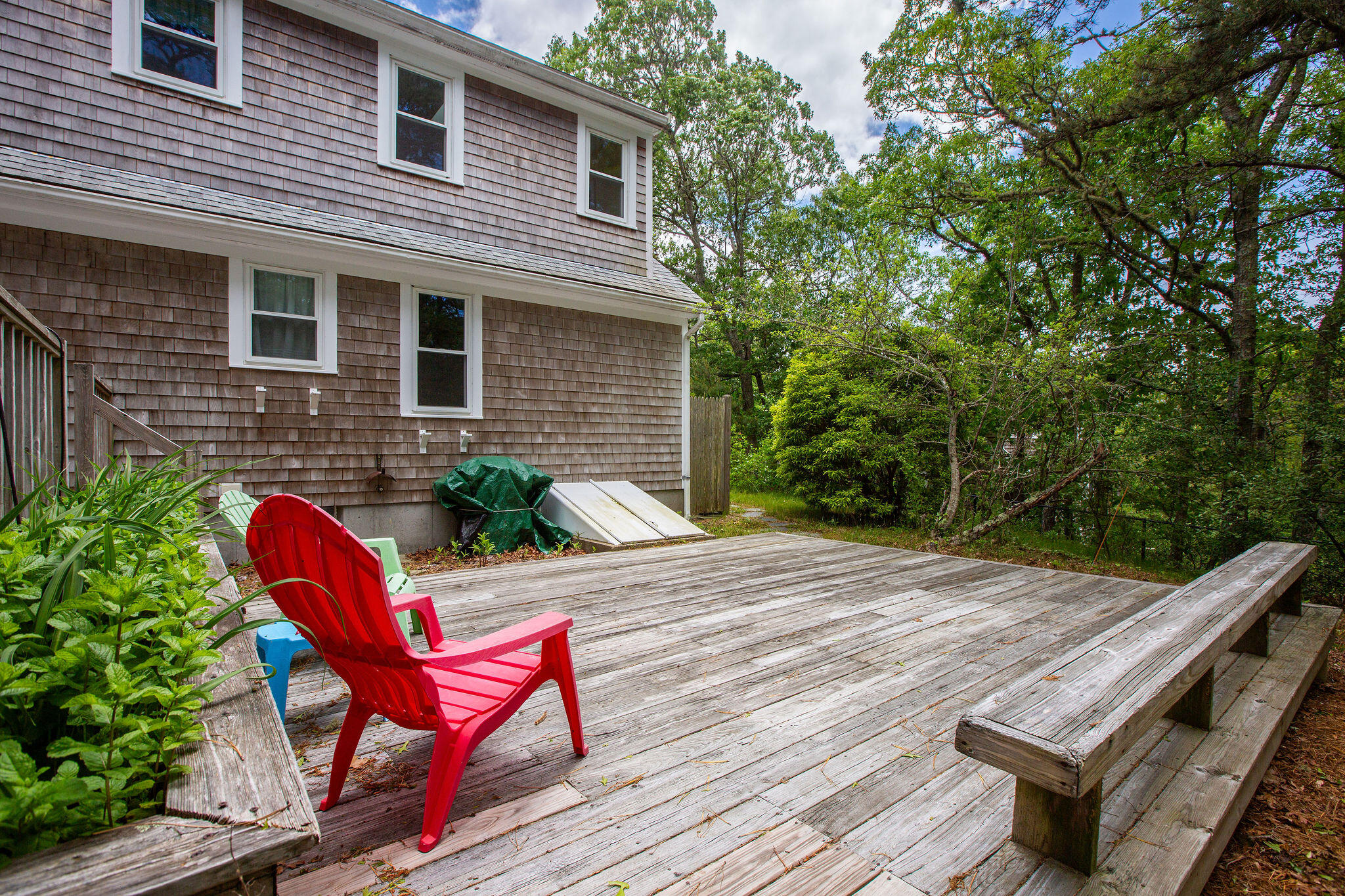 94 Pine View Drive Brewster, MA 02631 - Photo 8 of 51 a view of a patio with a table and chairs