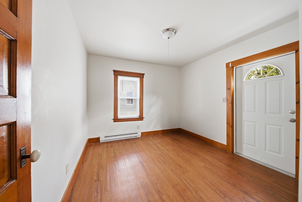 31 Whitcomb Street Webster, MA 01570 - Photo 11 of 39 an empty room with wooden floor and windows
