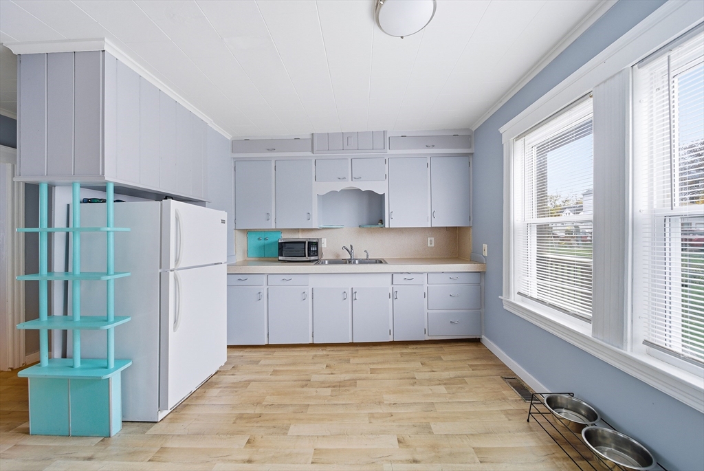 31 Whitcomb Street Webster, MA 01570 - Photo 15 of 39 a kitchen with granite countertop a refrigerator and a sink