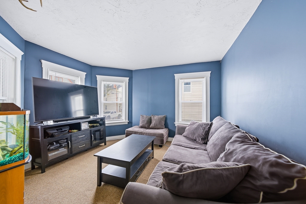 31 Whitcomb Street Webster, MA 01570 - Photo 19 of 39 a living room with furniture and a flat screen tv