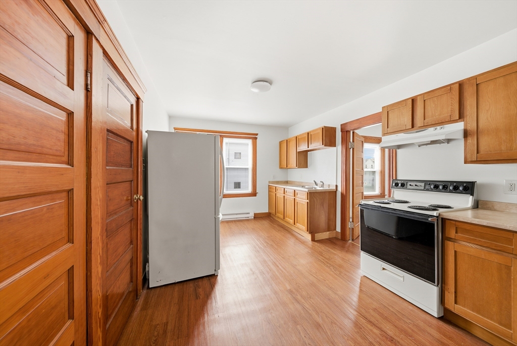 31 Whitcomb Street Webster, MA 01570 - Photo 2 of 39 a kitchen with stainless steel appliances granite countertop a refrigerator a stove and a wooden floors