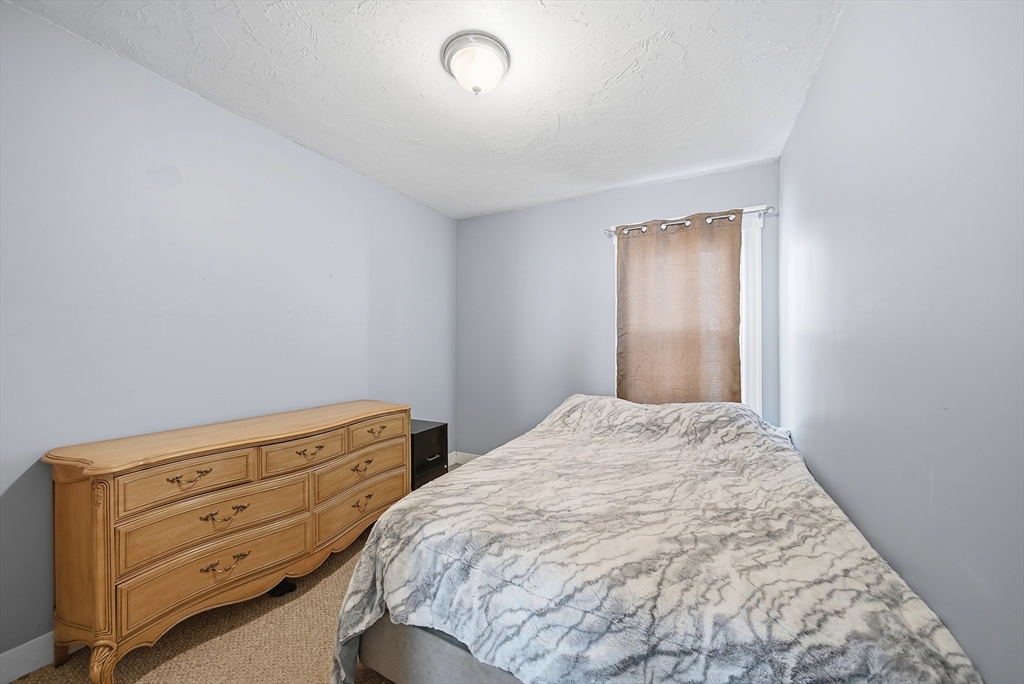 31 Whitcomb Street Webster, MA 01570 - Photo 24 of 39 a bedroom with a bed and a dresser