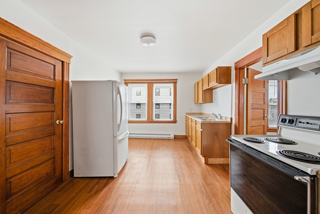 31 Whitcomb Street Webster, MA 01570 - Photo 3 of 39 a kitchen with a refrigerator a sink and wooden floor