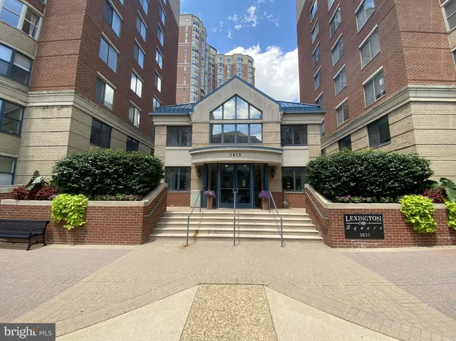 a front view of a residential apartment building with a yard