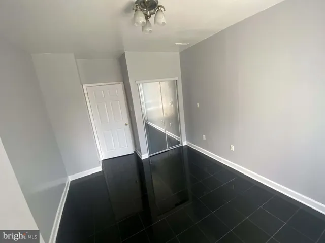 an empty room with windows and closet