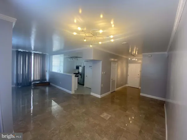 a view of entryway and hall with a chair