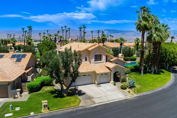 an aerial view of a houses with a lake view and a mountain view in back yard