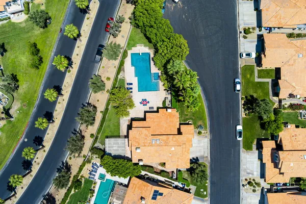 a view of a house with pool and chairs