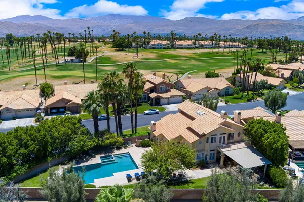 a view of a patio with table and chairs and potted plants